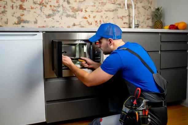 A person fixing microwave oven repair